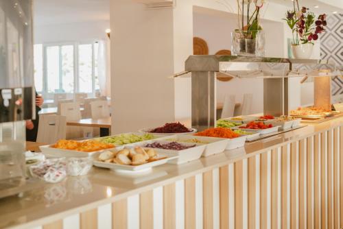 een buffet met veel verschillende soorten eten bij Hotel LLITERAS in Cala Ratjada