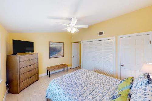 a bedroom with a bed and a ceiling fan at Canalside at KCB in Key Colony Beach