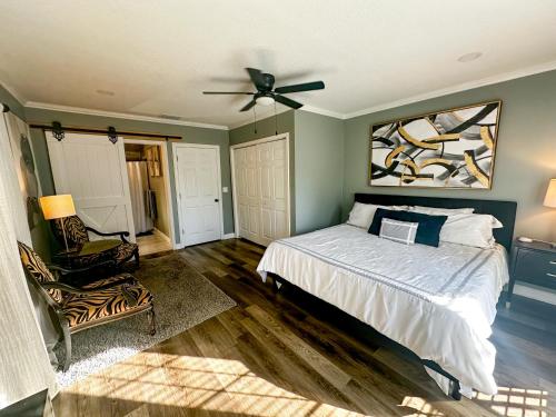 a bedroom with a bed and a ceiling fan at Youll Never Find A Bungalow Like Mine in Tampa