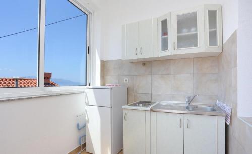 a small kitchen with a sink and a window at Apartments Aurora Adriatica in Brist