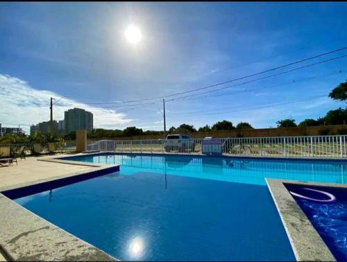 a large blue swimming pool with the moon in the sky at Apartamento Praia dos Milionários 3 Quartos e Ar condicionado in Ilhéus