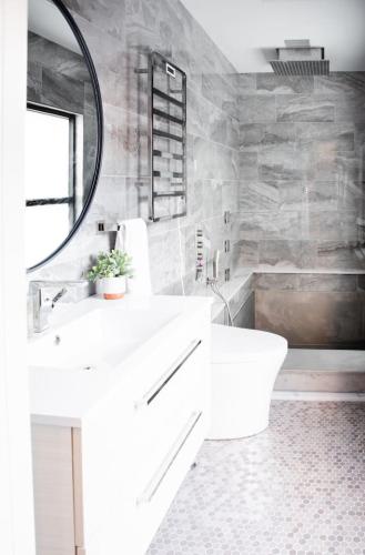 a white bathroom with a sink and a mirror at Sweet Lancaster Apt. B in Lancaster