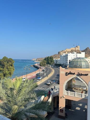 a view of a city with the ocean and a street at Muttrah Souq and Sea View in Muscat