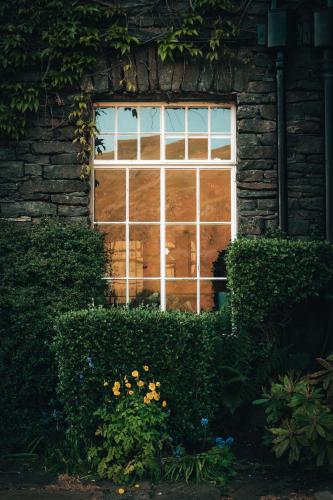 a window in a brick building with flowers in front of it at Haweswater Hotel in Bampton