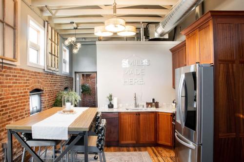 a kitchen with a table and a stainless steel refrigerator at Sweet Lancaster Apt. A in Lancaster