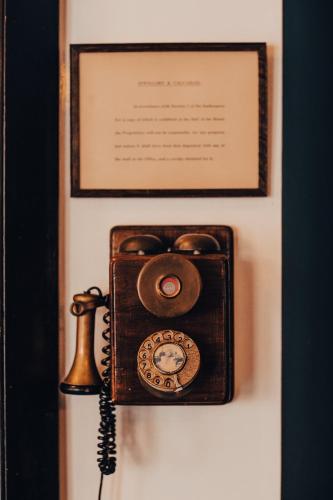 an old fashioned telephone is hanging on a wall at Haweswater Hotel in Bampton