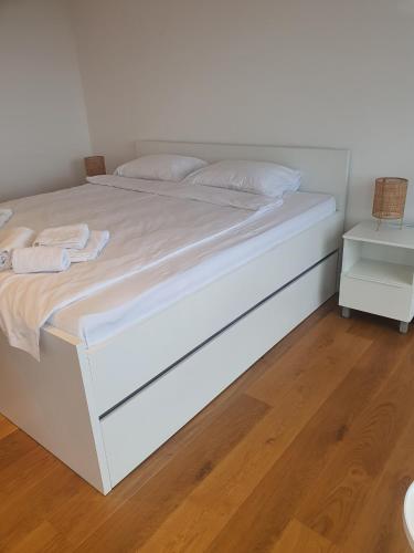 a white bed with white sheets and pillows on it at Villa Wineyard - VinoGrad in Banja Luka