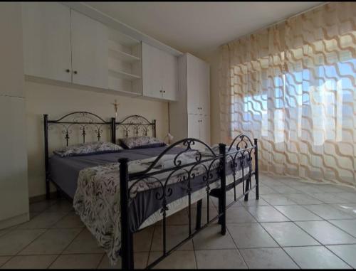 a bedroom with a bed and a window at Casa Piero in Lecce