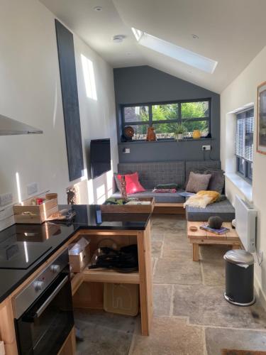 a kitchen and living room with a couch at The Watchmakers Matlock in Matlock