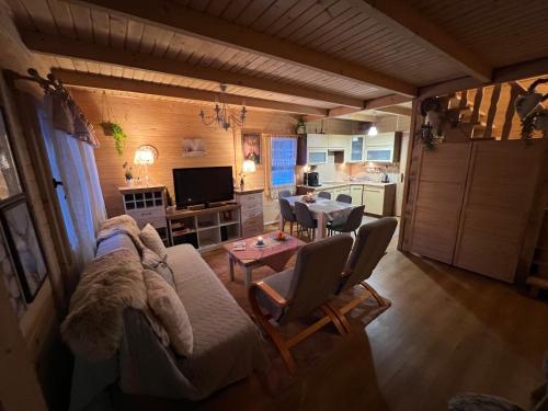 a living room with a couch and a table at Ustronne Chatki - Ostoja nad Potokiem in Ustroń