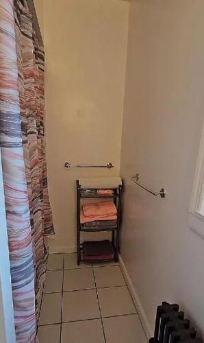 a bathroom with a towel rack in a room at Sylish 1 Bedroom Apartment in NYC! in New York
