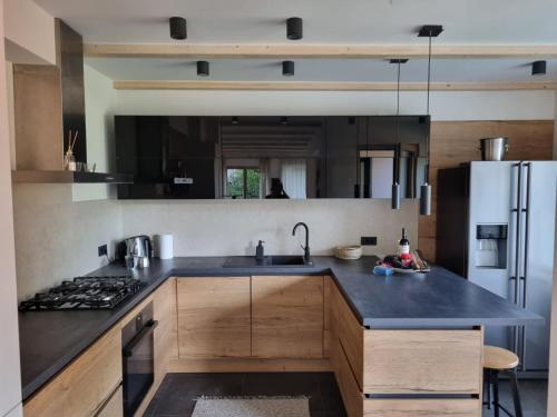 a kitchen with a sink and a refrigerator at Comfy mountain nest in Mojstrana