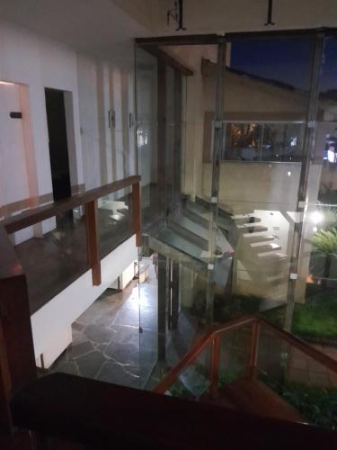 a view of a room with a glass balcony at Mansão Mar casado in Guarujá