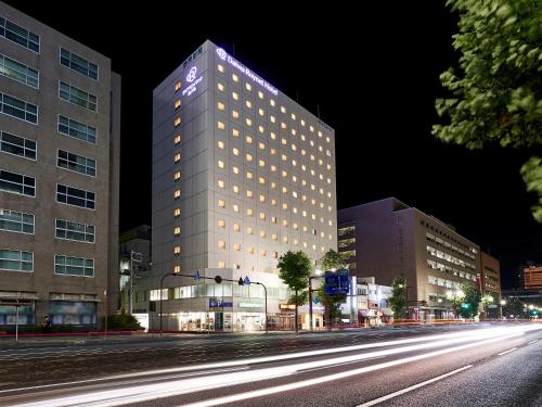 a tall building on a city street at night at Daiwa Roynet Hotel Hiroshima in Hiroshima