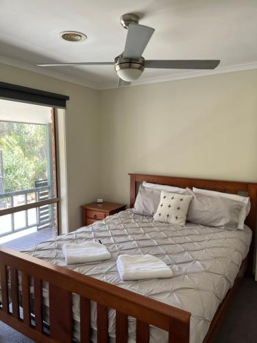 a bedroom with a large bed with two pillows at Echuca Retreat Holiday House in Echuca