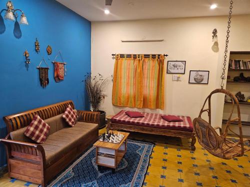 a living room with a couch and a table at A Chettinad villa in Coimbatore in Coimbatore