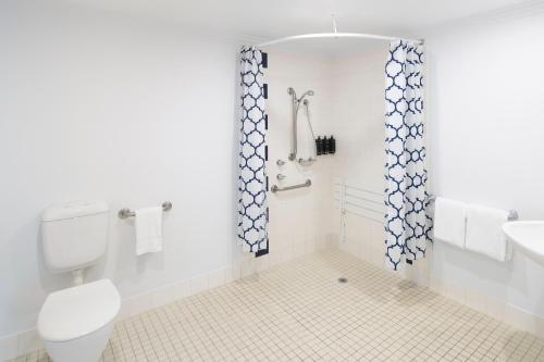 a bathroom with a toilet and a sink at Mercure Sydney Blacktown in Blacktown