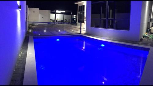 a large swimming pool with blue lighting in a house at VALLEY in Sikun Shikfainot