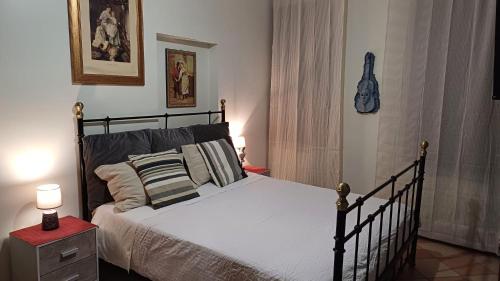 a bedroom with a bed and a red table with a lamp at La Dolce Venezia Guesthouse in Venice