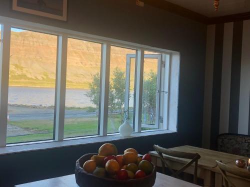 a bowl of fruit on a table in front of a window at Sea, fjord & mountain view house in Súðavík