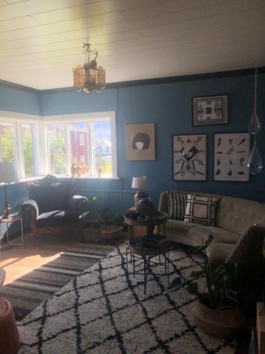 a living room with a couch and a rug at Sea, fjord & mountain view house in Súðavík