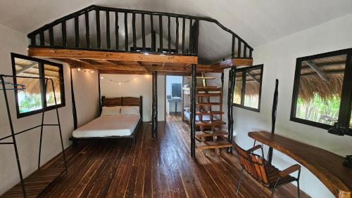 a room with a bunk bed and a staircase at Binga Beach Palawan Glamping in San Miguel