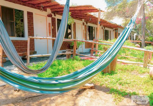 a blue hammock in front of a house at Rochabus in Ica