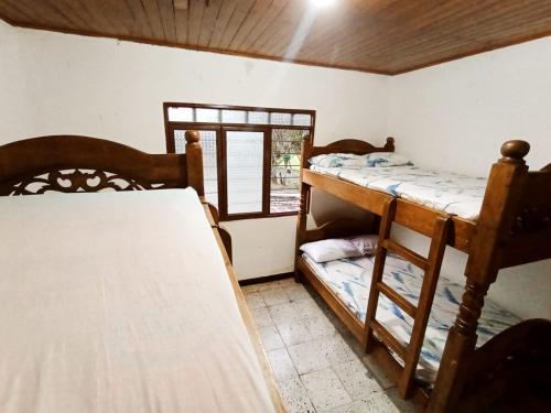a room with two bunk beds and a window at FINCA LA ESPERANZA 
