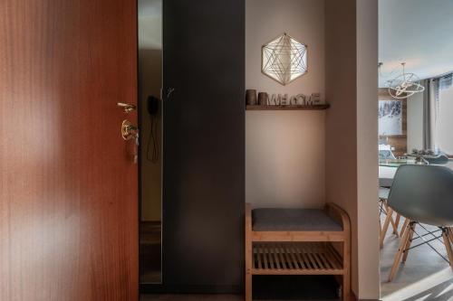 a room with a door and a chair and a table at Diamante ampio monolocale stile chalet alpino in Passo del Tonale