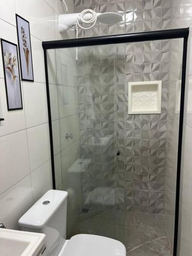 a bathroom with a shower and a white toilet at Kitnets Cidade de Goiás-Go 02 in Goiás