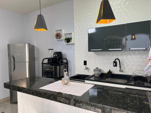 a kitchen with a sink and a refrigerator at Kitnets Cidade de Goiás-Go 02 in Goiás