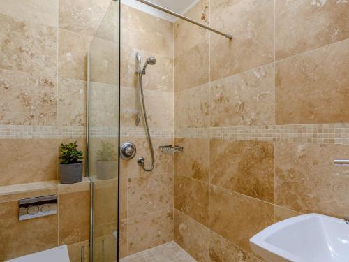 a bathroom with a shower and a sink at 3 Bed in Chester 82909 in Ledsham