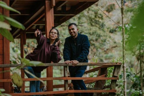 a man and a woman standing on a fence at Los Quetzales Ecolodge & Spa in Cerro Punta