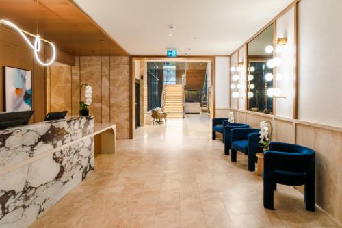 多伦多Sutton Place Hotel Toronto的大堂设有蓝色椅子等候室