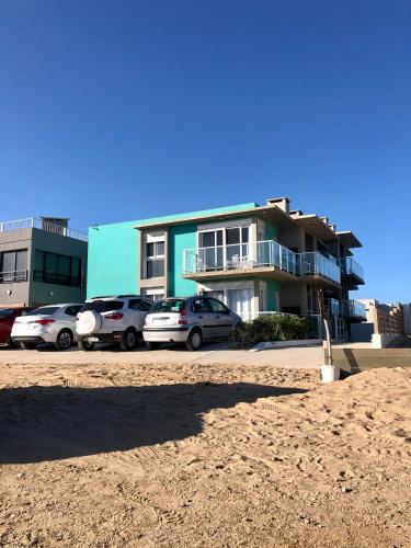 a group of cars parked in front of a building at Las Olas Aparts in La Paloma
