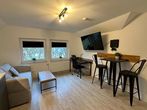 a living room with a couch and a table at MEINpartments - Full service living in Wolfsburg