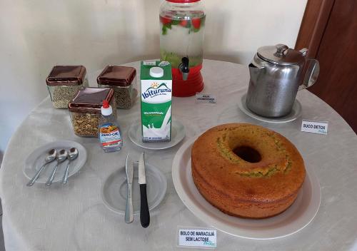 a table with a cake on a plate on a table at Acquamarine Park Hotel in Guarapari