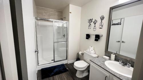 a bathroom with a shower and a toilet and a sink at Downtown Modern Luxury 2BD 2BA FREE PARKING in Indianapolis