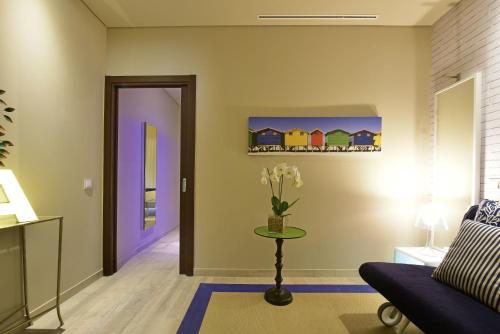 a living room with a blue couch and a table at Pestana Alvor South Beach Premium Suite Hotel in Alvor