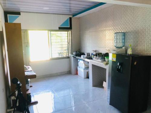 een keuken met een zwarte koelkast in de kamer bij Cabaña en Santiago de Tolú. in San Silvestre