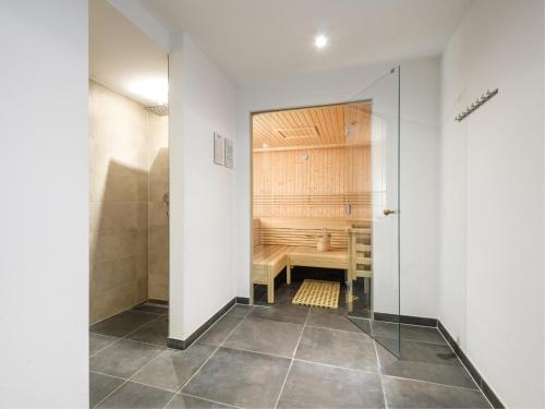 a bathroom with a bench and a shower in a room at Luxury Tauern Suite Walchen Kaprun 5 in Piesendorf
