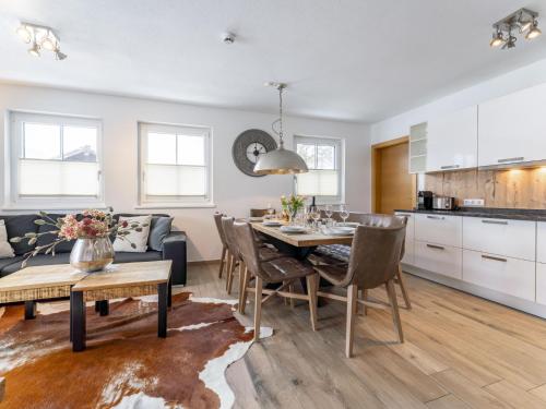 a kitchen and living room with a table and chairs at Luxury Tauern Suite Walchen Kaprun 5 in Piesendorf