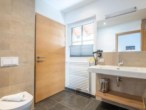 a bathroom with a sink and a mirror at Luxury Tauern Suite Walchen Kaprun 8 in Angerberg