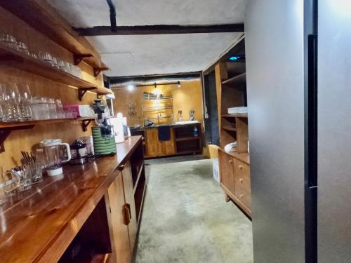 a large kitchen with wooden counters and a refrigerator at Luxury Traditional Chalet in Ha Giang