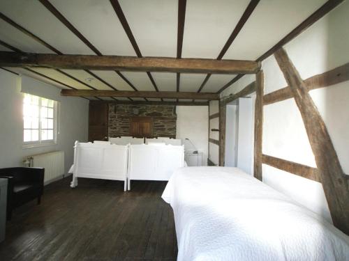 a bedroom with a white bed in a room at Mountain Retreat for Group in Daverdisse