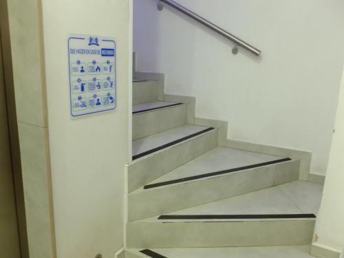 a staircase in a building with a sign on the wall at Hotel Estancia Real in Tepatitlán de Morelos
