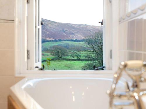a bath tub in a bathroom with a window at 3 Bed in Wasdale SZ315 in Nether Wasdale