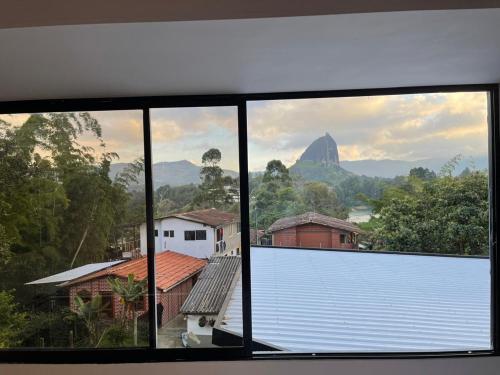 a view from a window of a city with a mountain at Hermoso apartamento en Guatape Antioquia in Guatapé