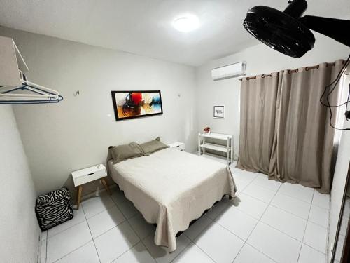 a bedroom with a bed in a room at Casa próxima à Praia do Coqueiro in Luis Correia