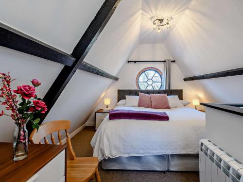 a attic bedroom with a bed and a window at 1 Bed in Sturminster Newton TOLDC in Sturminster Newton